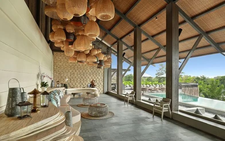 Open-air beach club lounge with rattan pendant lights